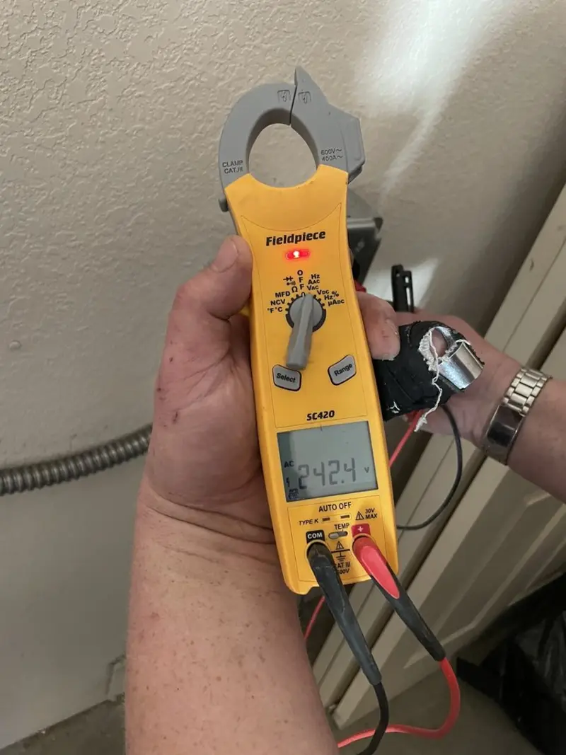 Voltage testing with clamp meter during Recessed Lighting Installation in Hallsville